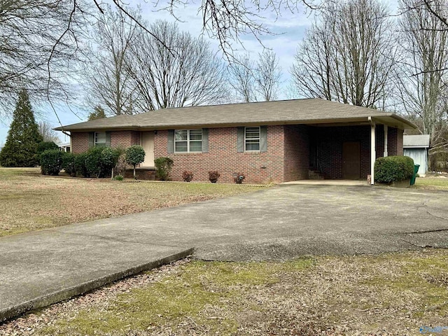 ranch-style house featuring a carport and a front yard