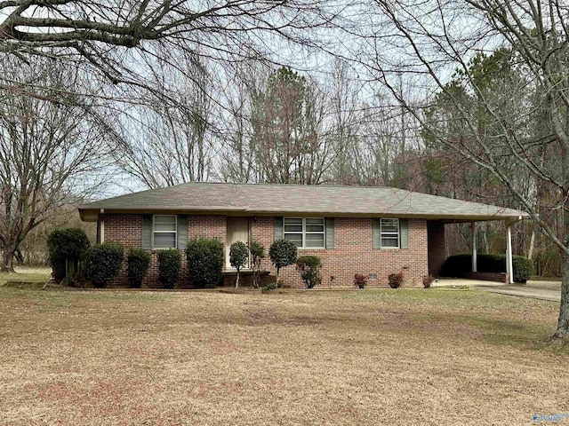 ranch-style home with a carport and a front yard