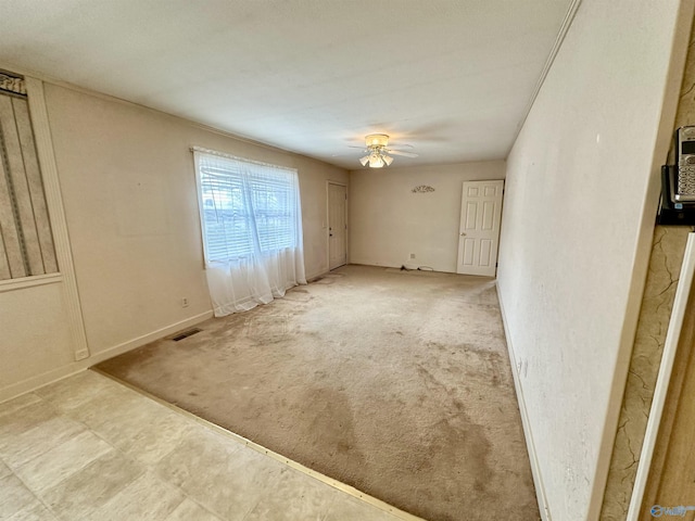 unfurnished room with light colored carpet and ceiling fan