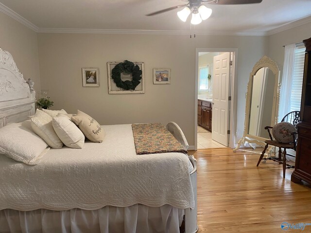 bedroom featuring ensuite bath, crown molding, light wood-type flooring, and ceiling fan