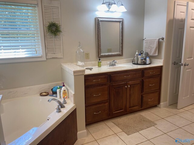 bathroom featuring vanity, tile patterned flooring, and a bathing tub