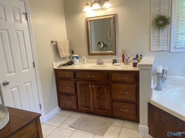 bathroom with vanity, tile patterned floors, and a tub to relax in