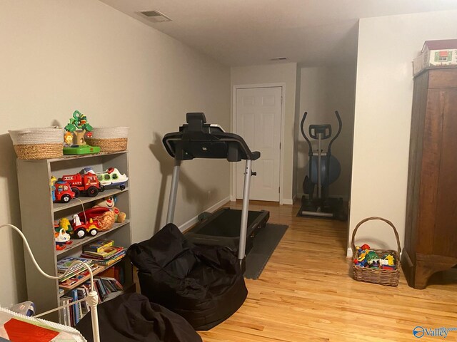 exercise area with light wood-type flooring