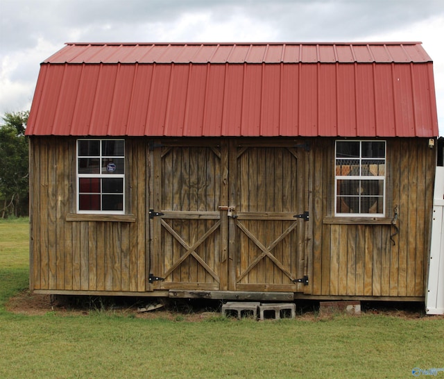 view of outbuilding with a yard