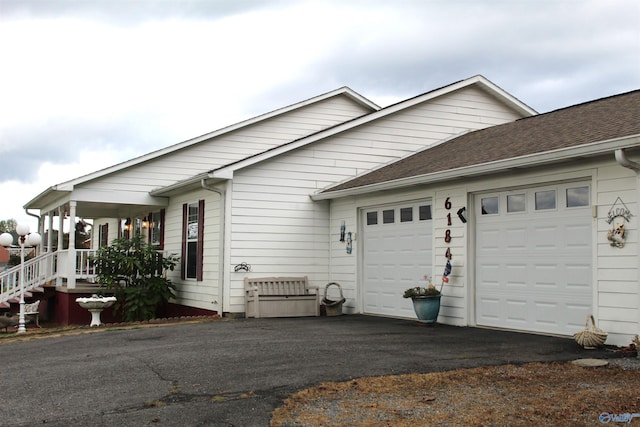 exterior space featuring a porch and a garage