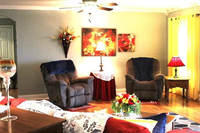 living room featuring ornamental molding, ceiling fan, and hardwood / wood-style flooring