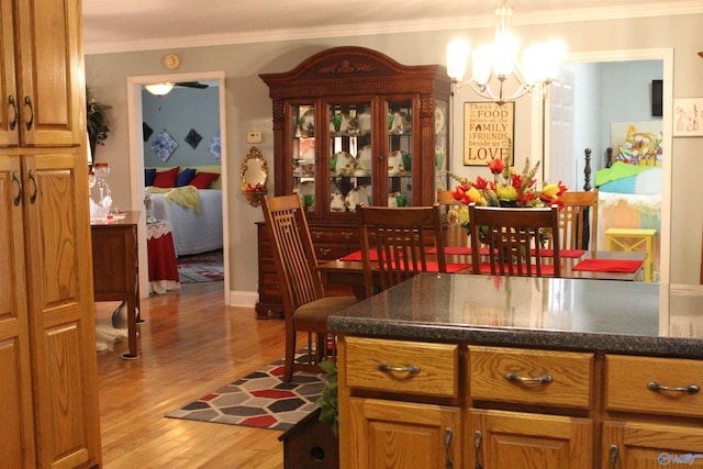 interior space featuring crown molding, an inviting chandelier, and hardwood / wood-style flooring