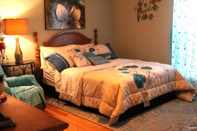 bedroom with hardwood / wood-style flooring