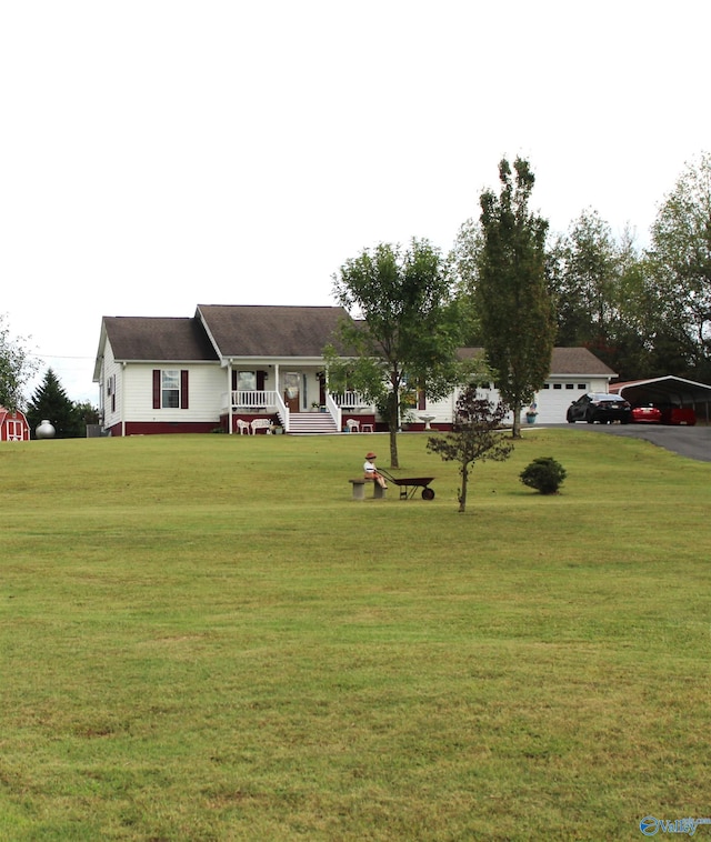 view of yard with a garage and covered porch