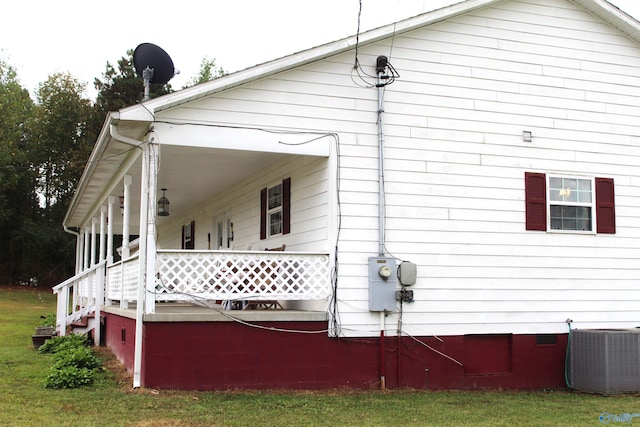 view of property exterior with central AC unit and a lawn