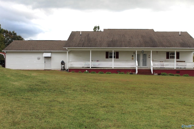 back of property with a porch and a yard