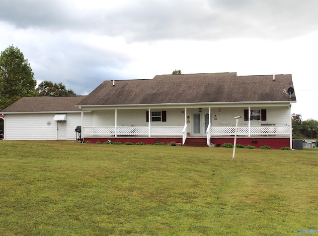 rear view of house featuring a lawn and covered porch