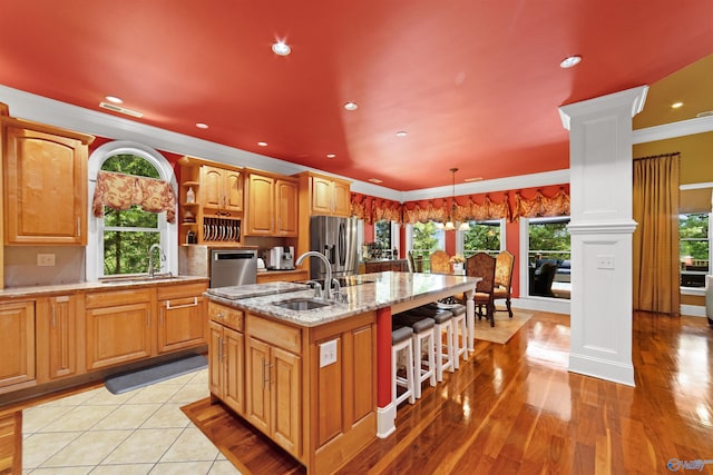 601 Smokey Mountain Cir, Huntsville, AL 35803 - kitchen with stainless steel fridge with ice dispenser, a sink, ornate columns, an island with sink, and recessed lighting