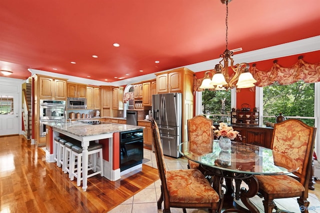 601 Smokey Mountain Cir, Huntsville, AL 35803 - kitchen with appliances with stainless steel finishes, a chandelier, light stone countertops, a kitchen island with sink, and recessed lighting
