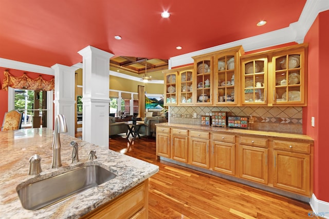 601 Smokey Mountain Cir, Huntsville, AL 35803 - kitchen featuring a sink, crown molding, ornate columns, decorative backsplash, and light wood-type flooring