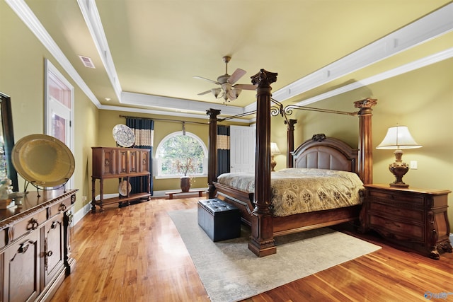 601 Smokey Mountain Cir, Huntsville, AL 35803 - bedroom with a tray ceiling, ornamental molding, light wood-type flooring, and baseboards