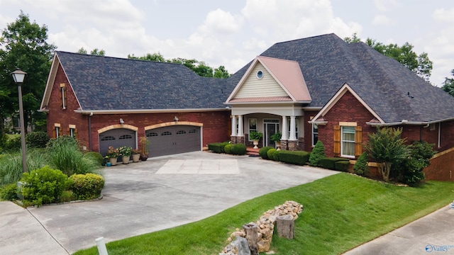 601 Smokey Mountain Cir, Huntsville, AL 35803 - view of front facade with brick siding, covered porch, concrete driveway, and a garage