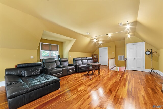 601 Smokey Mountain Cir, Huntsville, AL 35803 - living area featuring light wood-type flooring, vaulted ceiling, and baseboards