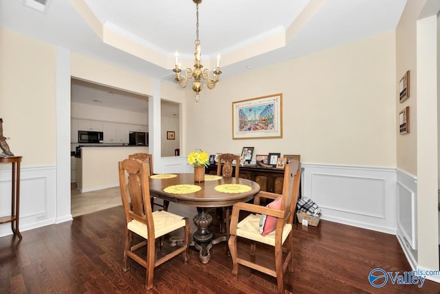 77 Valley Way Cir SE Unit 77, Huntsville, AL 35802 - dining room with a raised ceiling, a chandelier, crown molding, dark wood-type flooring, and a decorative wall