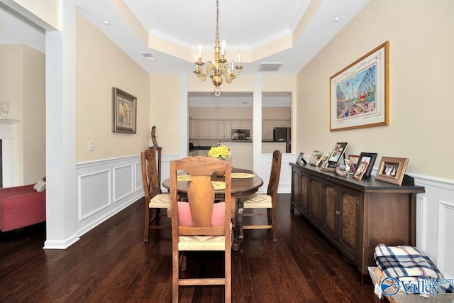 77 Valley Way Cir SE Unit 77, Huntsville, AL 35802 - dining space with a raised ceiling, a chandelier, dark wood-style flooring, a wainscoted wall, and ornamental molding