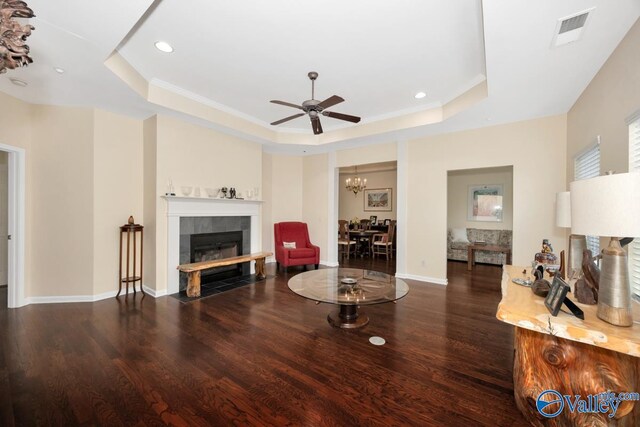 77 Valley Way Cir SE Unit 77, Huntsville, AL 35802 - living area with a tray ceiling, wood finished floors, a fireplace, a ceiling fan, and a chandelier