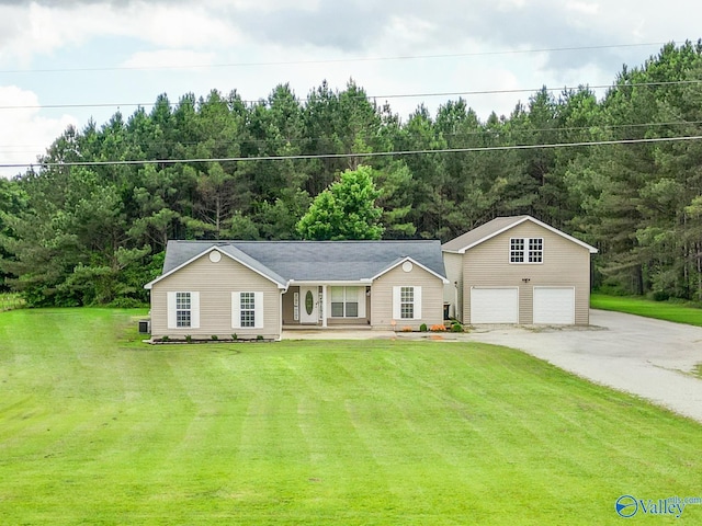 681 Union Rd, Somerville, AL 35670 - view of front facade featuring a garage, an outbuilding, a front lawn, driveway, and a porch