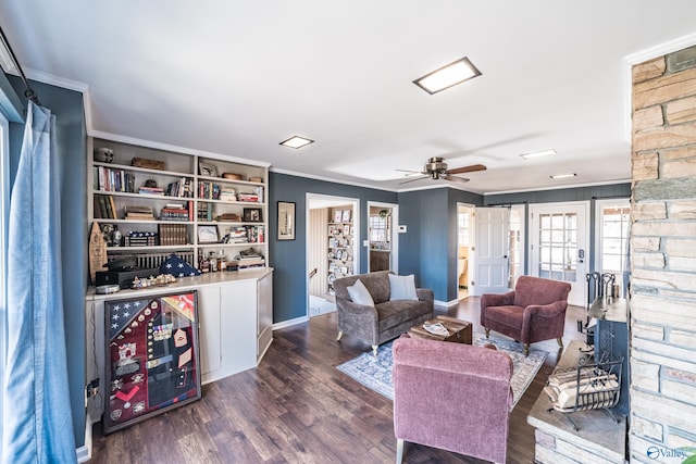 living room with ornamental molding, dark hardwood / wood-style floors, and ceiling fan