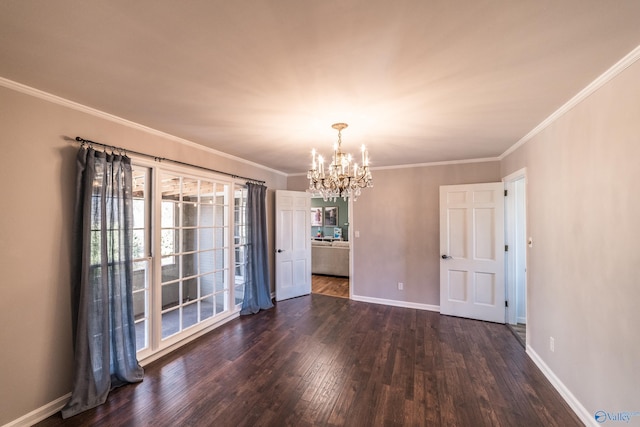 empty room featuring ornamental molding, dark hardwood / wood-style floors, and a chandelier