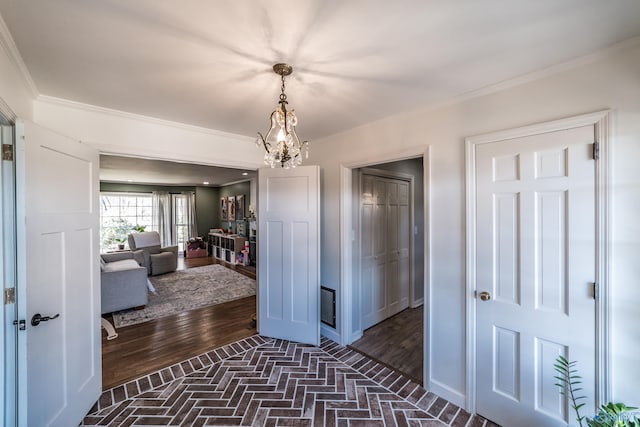 corridor featuring a notable chandelier and ornamental molding