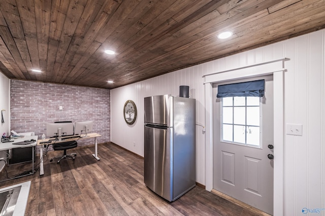 kitchen with brick wall, wooden ceiling, dark hardwood / wood-style floors, and stainless steel fridge