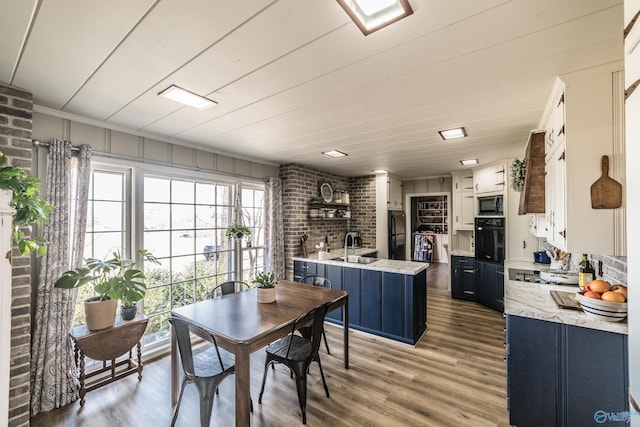 dining room with sink and light hardwood / wood-style floors