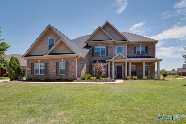 craftsman house with a porch and a front lawn