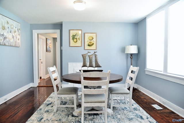 dining space featuring dark hardwood / wood-style floors