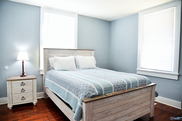 bedroom with dark hardwood / wood-style floors