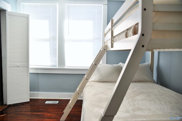 bedroom with dark hardwood / wood-style flooring