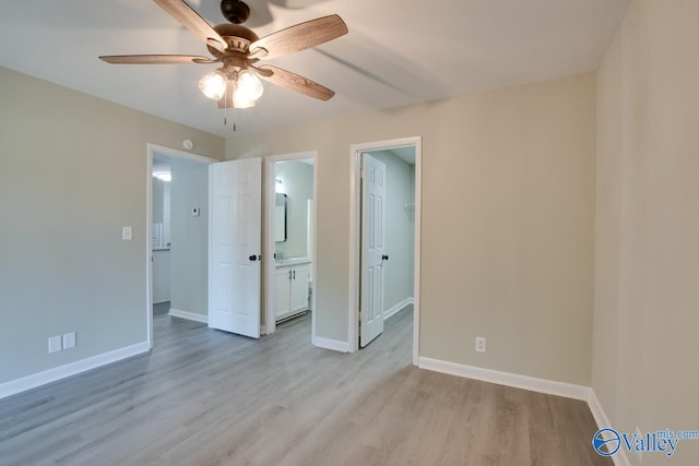 unfurnished bedroom featuring hardwood / wood-style flooring, connected bathroom, and ceiling fan