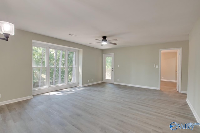 empty room featuring light wood-type flooring and ceiling fan