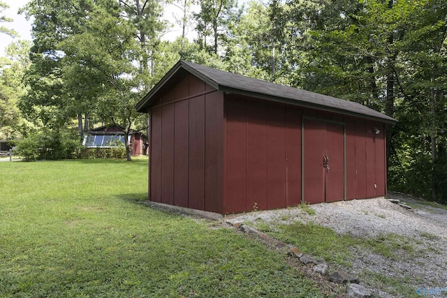 view of outbuilding featuring a lawn