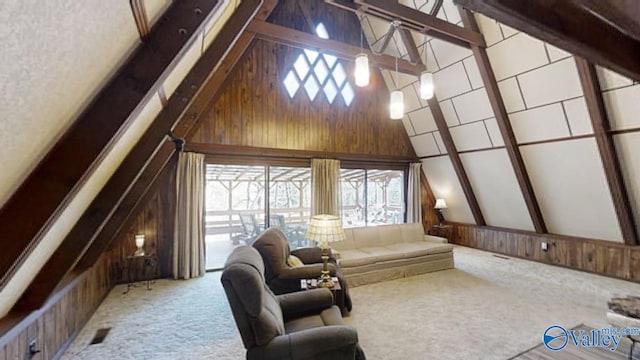 interior space with beamed ceiling, carpet flooring, wooden walls, and high vaulted ceiling