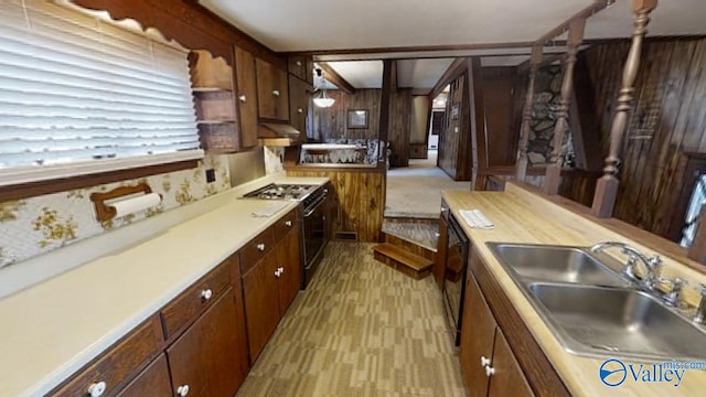 kitchen with wall chimney exhaust hood, sink, light carpet, black dishwasher, and stove