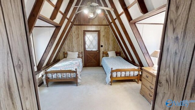 carpeted bedroom featuring wood walls