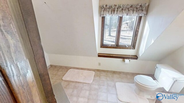 bathroom with tile patterned flooring and toilet