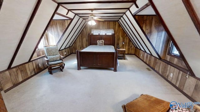 carpeted bedroom with multiple windows, wooden walls, and lofted ceiling