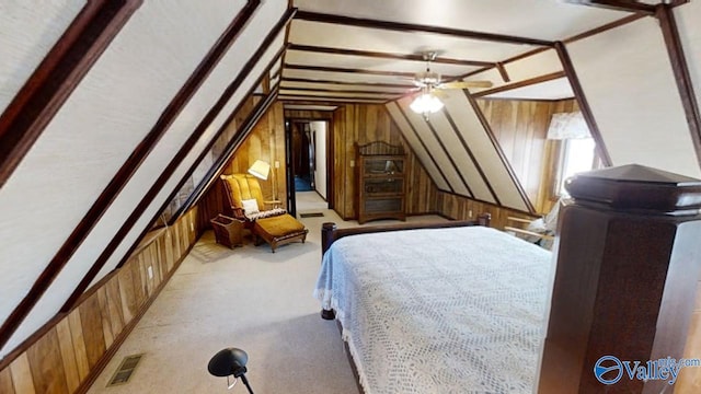 carpeted bedroom featuring vaulted ceiling and wooden walls