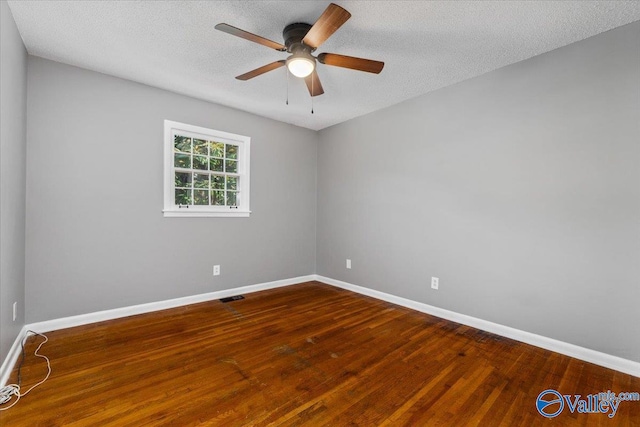 spare room with a textured ceiling, hardwood / wood-style flooring, and ceiling fan