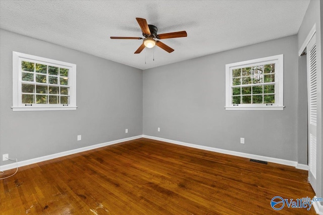 unfurnished room featuring hardwood / wood-style floors, a textured ceiling, and ceiling fan