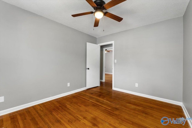 unfurnished room featuring hardwood / wood-style floors, a textured ceiling, and ceiling fan