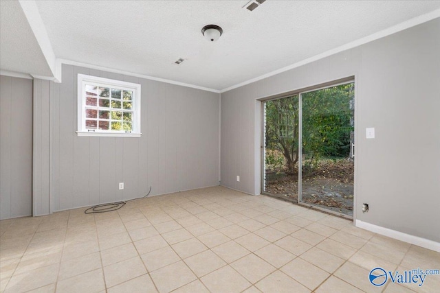 tiled empty room featuring wood walls and ornamental molding