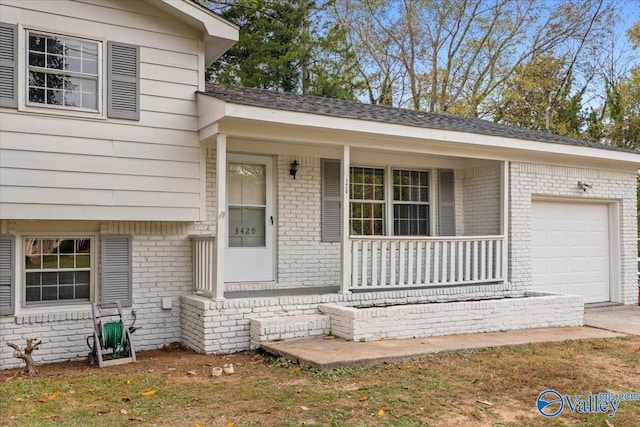 view of front of property featuring a garage and a porch