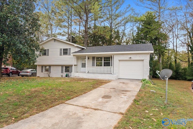 split level home with a garage, a porch, and a front lawn